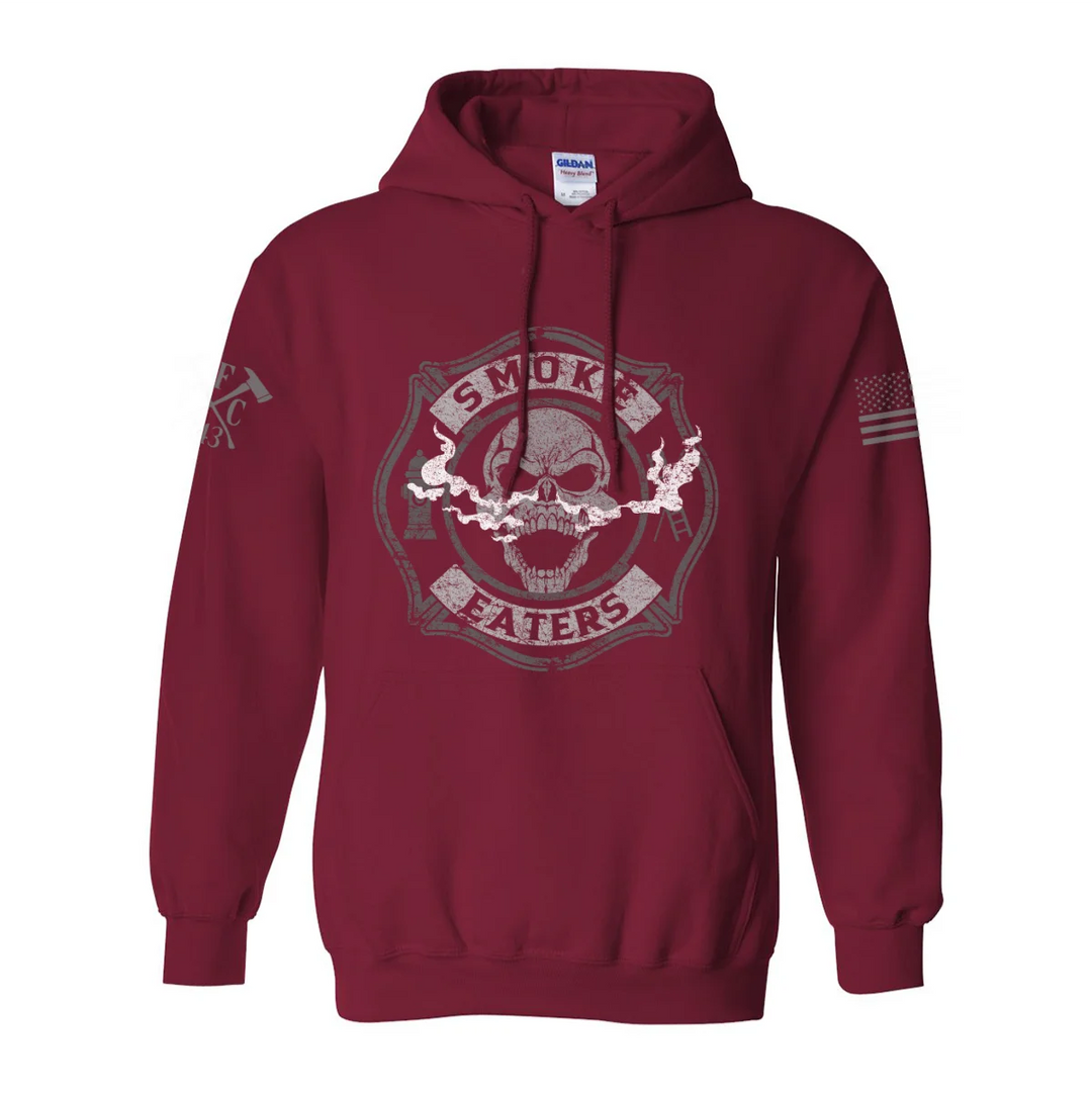 Front view of firefighter hoodies in red color featuring a full-front design print of a skull inhaling smoke, with a distressed grey and off-white look.