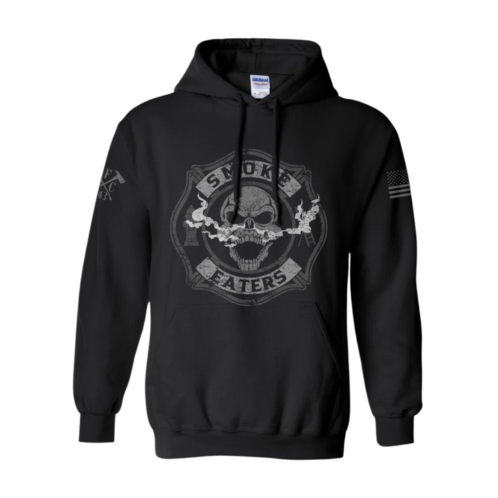 Front view of firefighter hoodies in black color featuring a full-front design print of a skull inhaling smoke, with a distressed grey and off-white look.