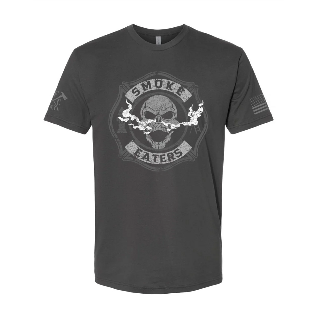 Front view of firefighter T-Shirt in heavy metal color featuring a full-front design print of a skull inhaling smoke, with a distressed grey and off-white look.