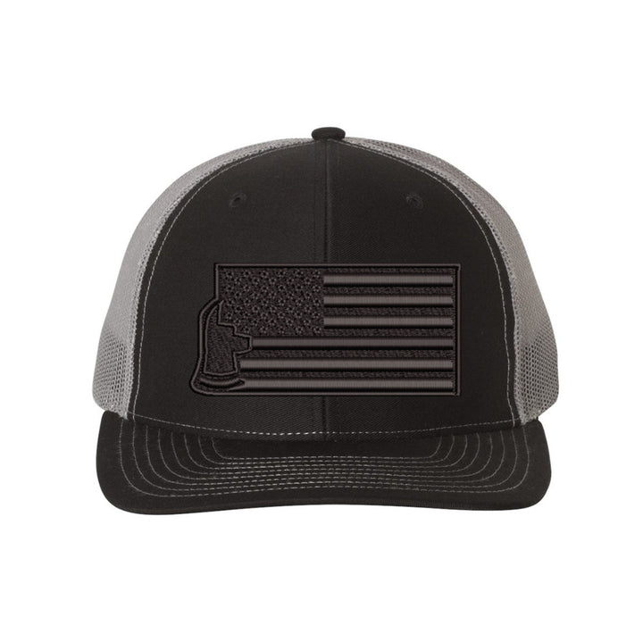 Close-up of the embroidered "Thin Red Line Axe Maltese" logo on the front of the Blackout Delta FlexFit Hat, highlighting the sharp design details.