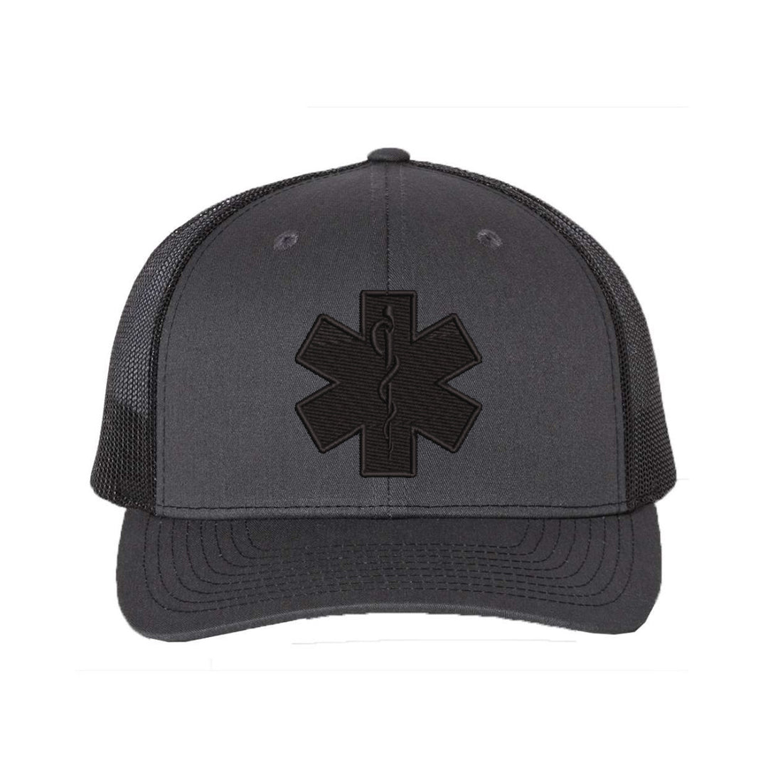 Close-up of the Star of Life emblem embroidered in black on a snapback trucker hat