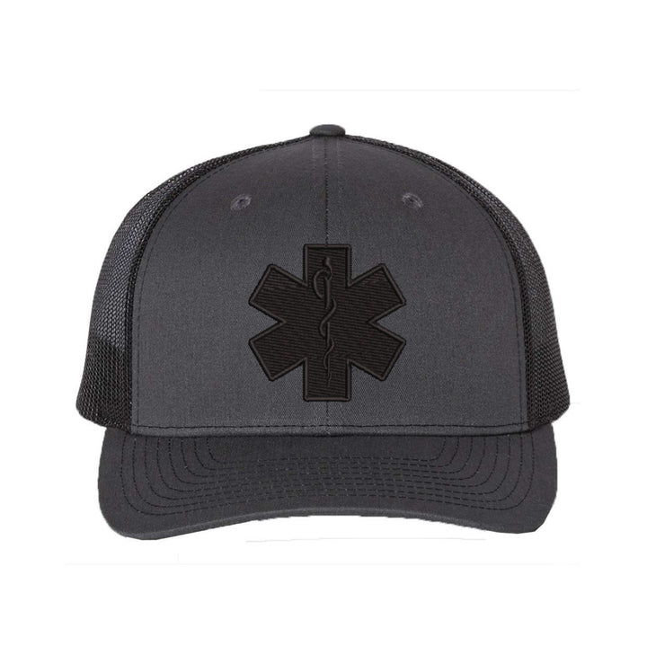 Close-up of the Star of Life emblem embroidered in black on a snapback trucker hat