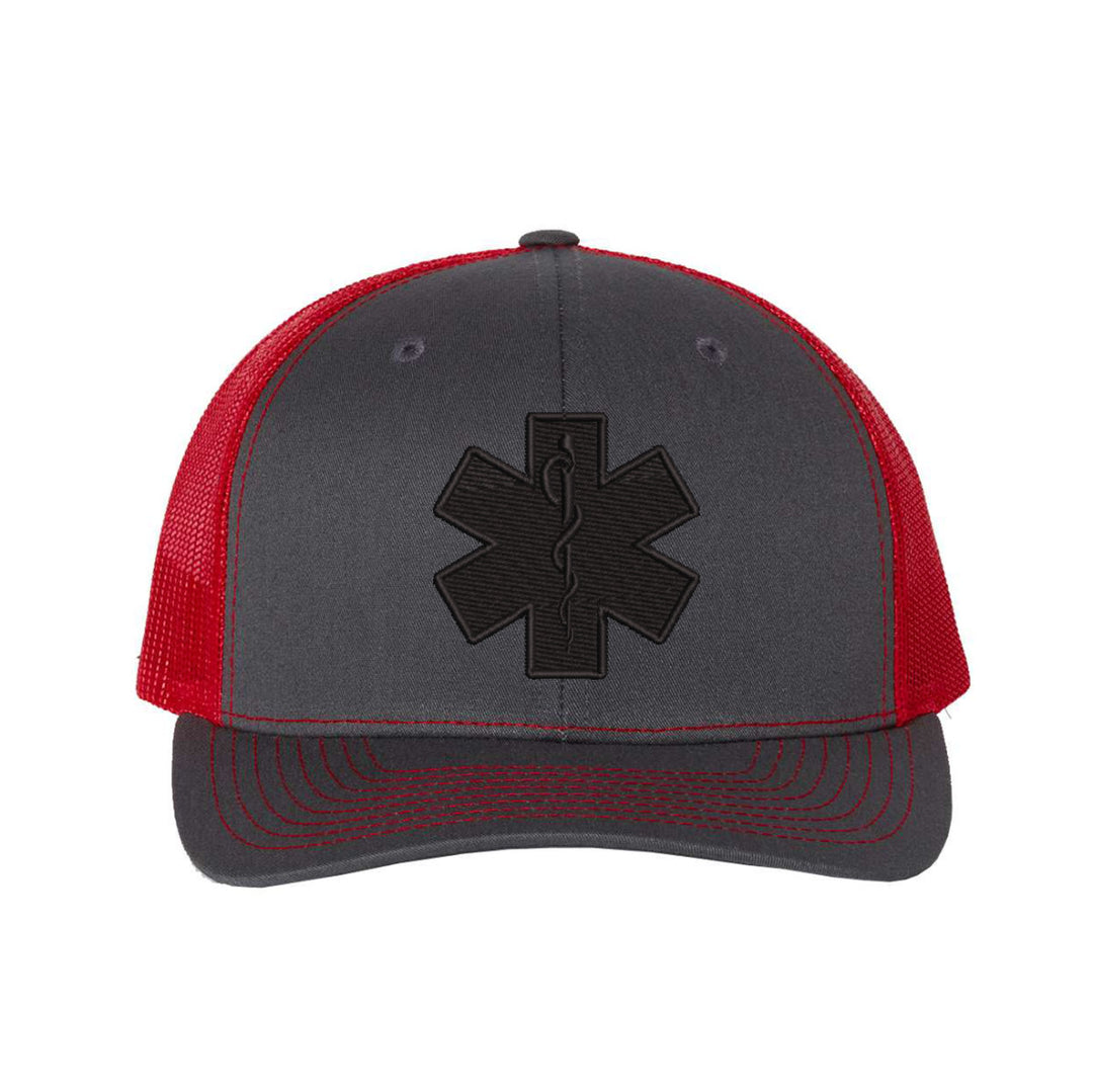Front view of the Star of Life embroidered blackout snapback trucker hat.