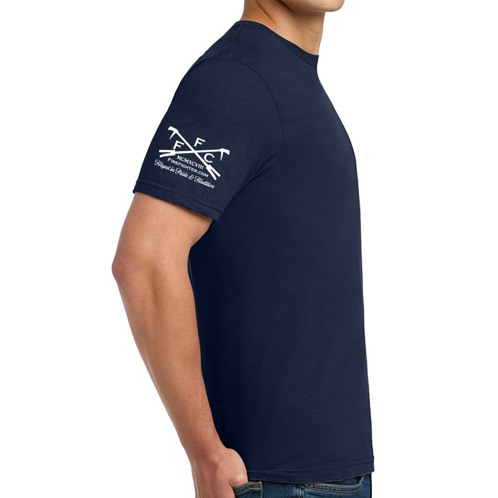A man wearing a navy blue short-sleeve t-shirt with a white printed graphic on the right sleeve. Official logo of FFC #color_navy