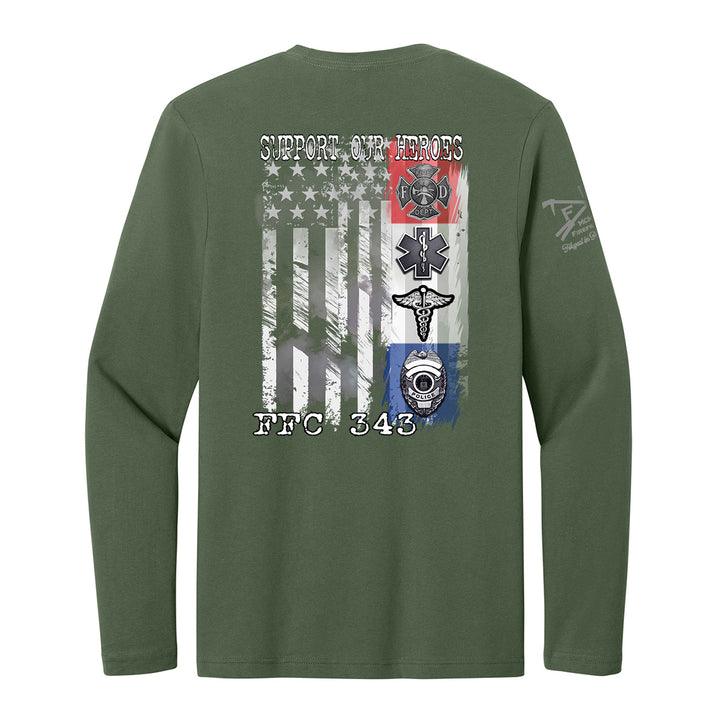 An olive green long-sleeve t-shirt shown from the back, featuring a large graphic print of a distressed American flag with military and first responder emblems, including a firefighter cross, EMT star, paramedic cross, and diving mask. The text 'SUPPORT OUR HEROES' is printed above the flag, and 'FBC 343' is printed below. #color_military-green