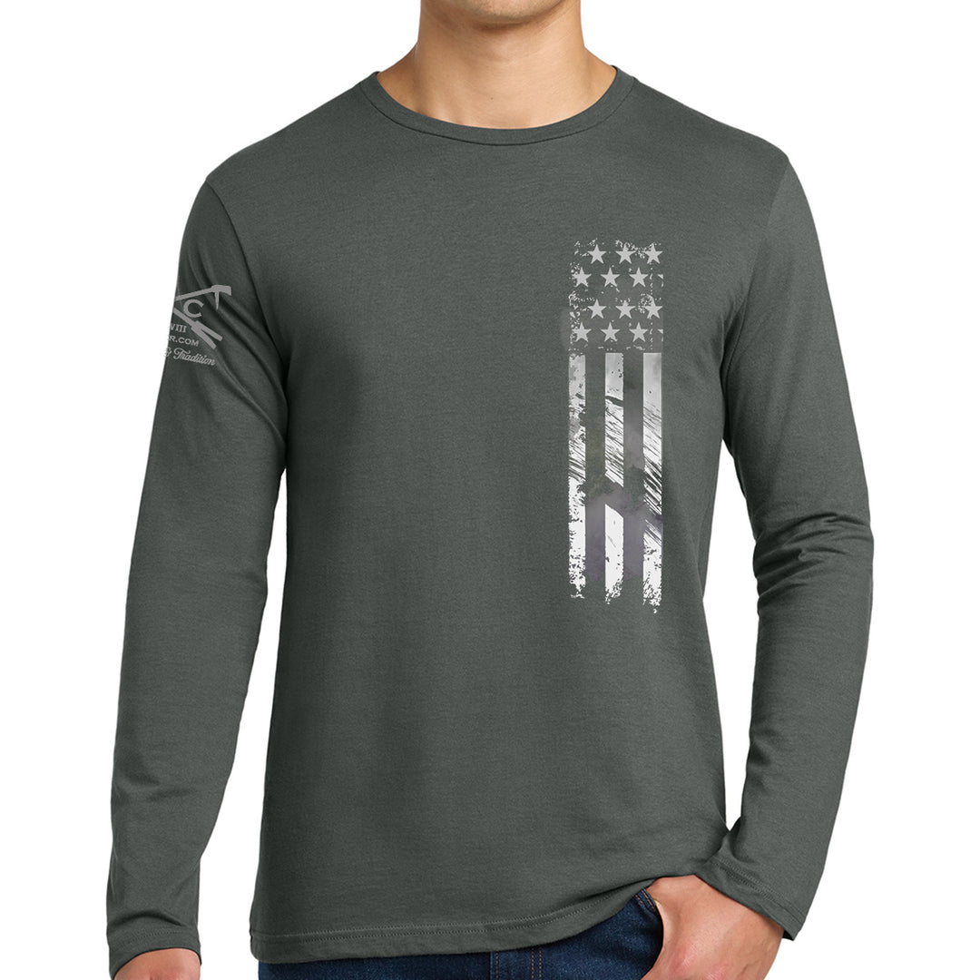 A man wearing a dark gray long-sleeve t-shirt with a distressed vertical American flag graphic on the front and a logo on the left sleeve, set against a plain white background. Support Our Heroes Black Long Sleeves Shirt  #color_charcoal