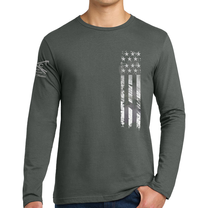 A man wearing a dark gray long-sleeve t-shirt with a distressed vertical American flag graphic on the front and a logo on the left sleeve, set against a plain white background. Support Our Heroes Black Long Sleeves Shirt  #color_charcoal