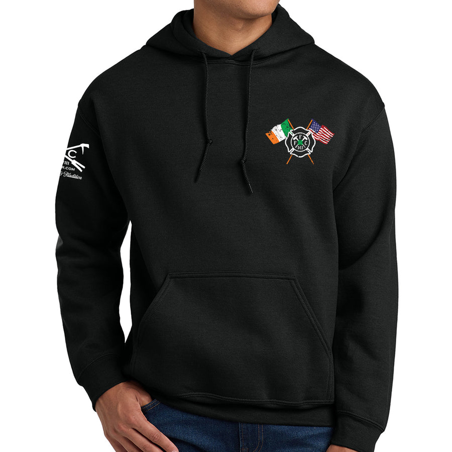 A man wearing a black pullover hoodie with a small chest graphic of crossed Irish and American flags and a fire department emblem, shown against a plain white background. #color_black