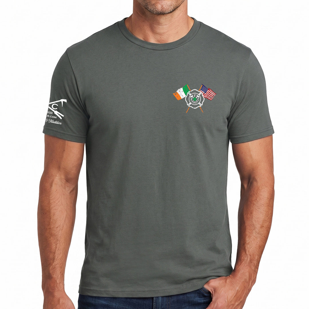 A man wearing a dark gray crewneck t-shirt with a small graphic on the left chest featuring crossed Irish and American flags and a fire department emblem, with a white graphic on the right sleeve. #color_charcoal