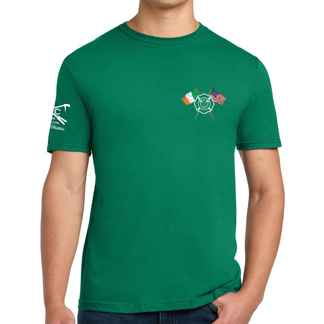 A man wearing a green crewneck t-shirt with a small graphic on the left chest featuring crossed flags and a circular emblem, and a FFC logo white graphic on the right sleeve. #color_kelly-green