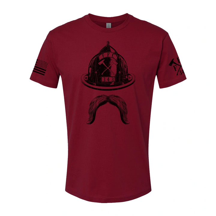 Front view of firefighter T-Shirt in cardinal red color with a full  front print of Firefighter helmet and a mustache design perfect for fire department apparel.