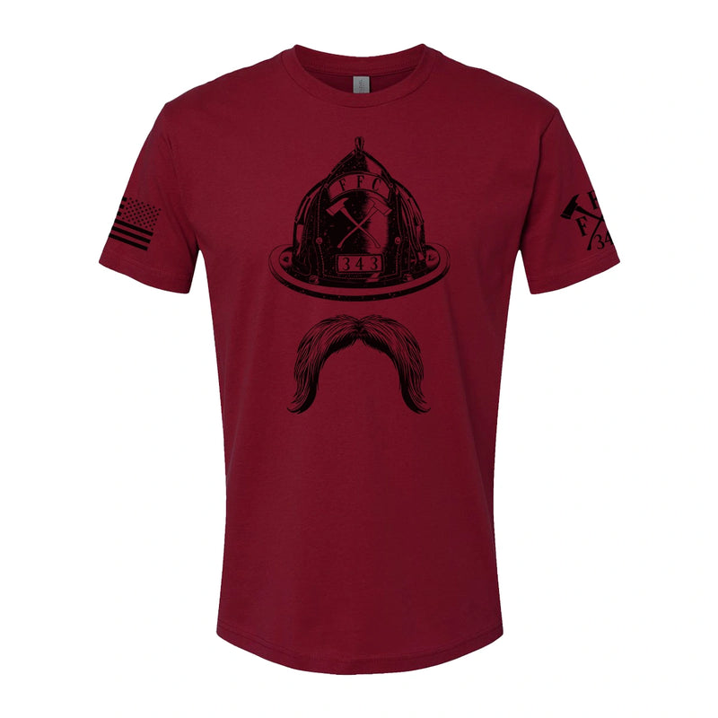 Front view of firefighter T-Shirt in cardinal red color with a full  front print of Firefighter helmet and a mustache design perfect for fire department apparel.