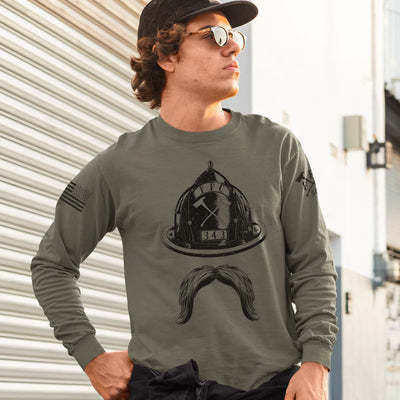 A man wearing a military green firefighter long sleeve shirt with a full front design featuring a firefighter helmet and mustache.