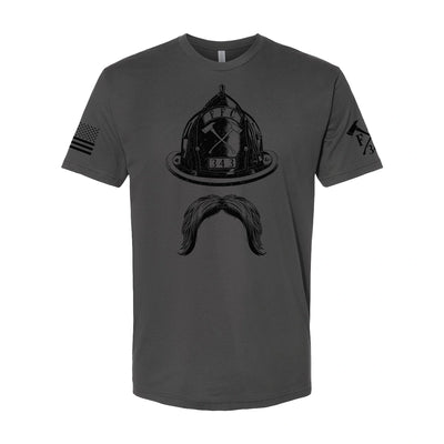 Firefighter t-shirt in heavy metal gray with bold front print of firefighter helmet and mustache. Left sleeve displays firefighter logo, right sleeve has USA flag