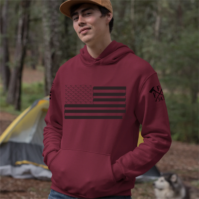 A man wearing a red firefighter hoodies shirt with a full front design of USA flag and a sword design