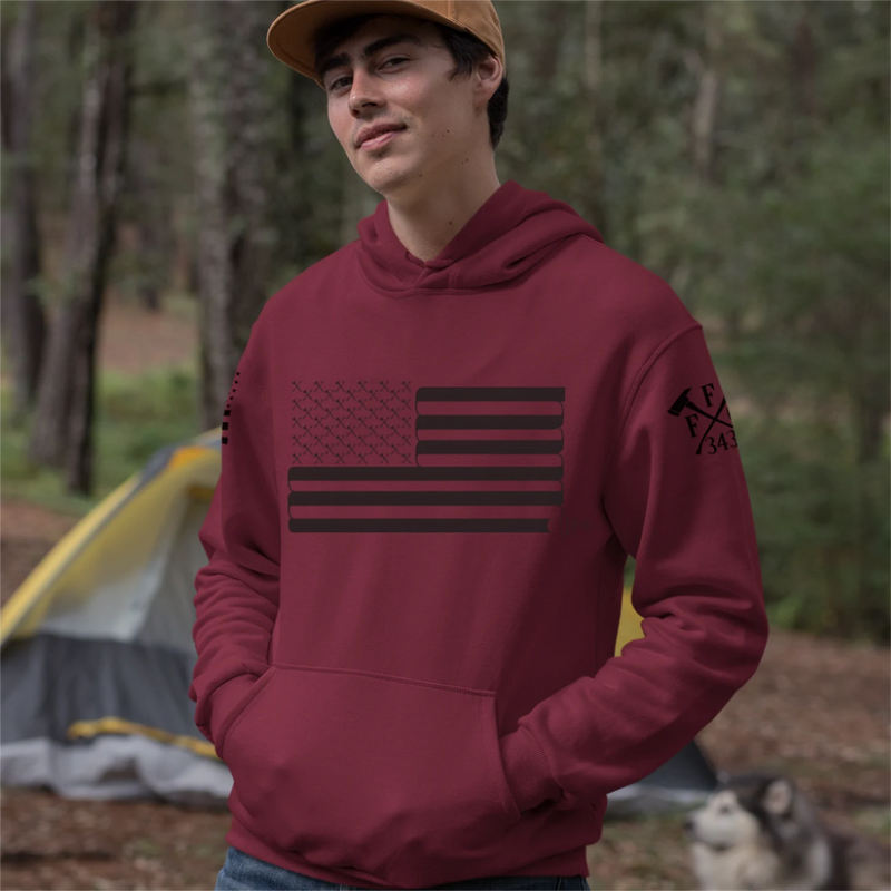 A man wearing a red firefighter hoodies shirt with a full front design of USA flag and a sword design