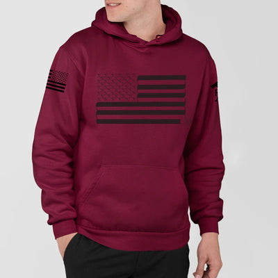 A man wearing a grey firefighter hoodies shirt with a full front design of USA flag and a sword design