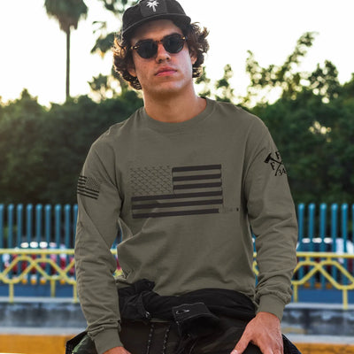 A man wearing a military green firefighter long sleeve shirt with a full front design of USA flag and a sword design