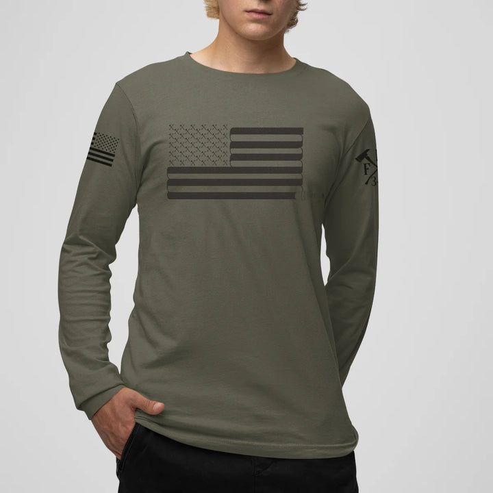 A man wearing a military green firefighter long sleeve shirt with a full front print of USA flag and a sword design perfect for fire department apparel