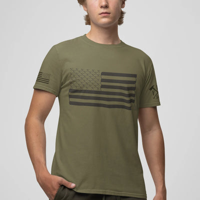 A man wearing a firefighter T-shirt in military green with a full front design featuring a USA flag and a sword.