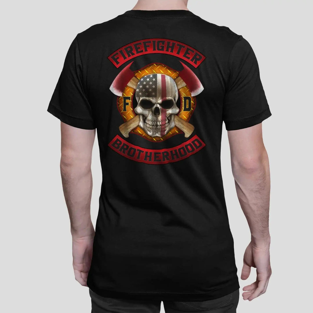 A man wearing a black firefighter T-shirt with a full back design featuring a  featuring a full back print of a skull design with an American flag and crossed axes