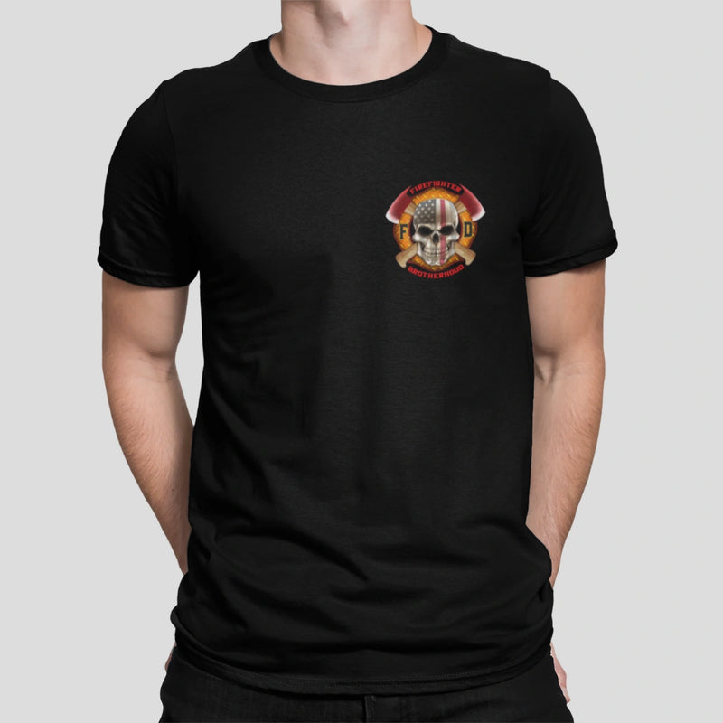 A man wearing a black firefighter T-shirt with a left chest print featuring a skull design with an American flag and crossed axes