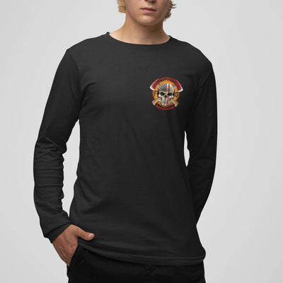 A man wearing a black firefighter long sleeve shirt with a left chest print design of a skull design with an American flag and crossed axe