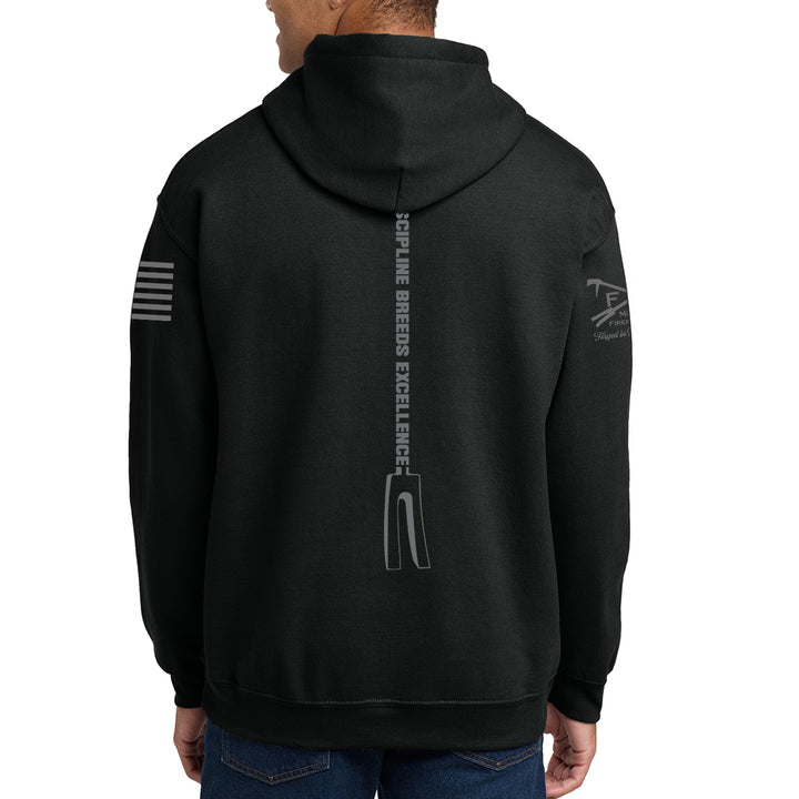 A person shown from the back wearing a black pullover hoodie with gray printed graphics on the back and sleeves, paired with blue jeans against a plain white background. #color_black