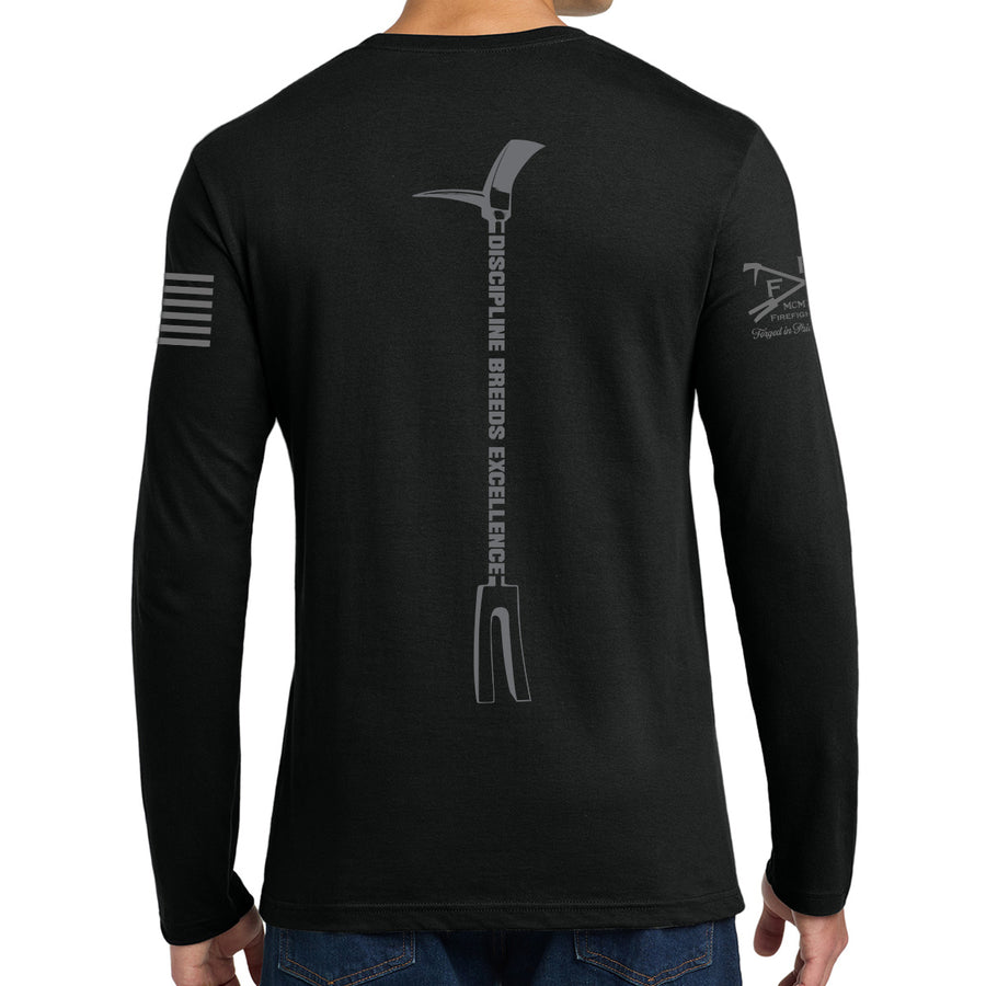 A man wearing a black long-sleeve t-shirt, viewed from the back. The shirt features a large gray graphic of a pickaxe with the text 'DISCIPLINE BREEDS EXCELLENCE' printed vertically down the center back. #color_black