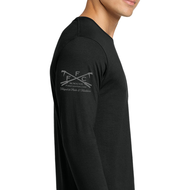 A man wearing a black long-sleeve t-shirt, shown from the side profile against a plain white background. The shirt features a gray printed graphic on the upper left shoulder with crossed tools and the text ffc #color_black