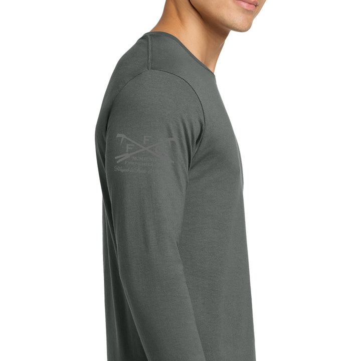 A man wearing a dark gray long-sleeve shirt, shown in a side profile against a plain white background. A subtle gray graphic logo is printed on the upper left sleeve.  #color_charcoal