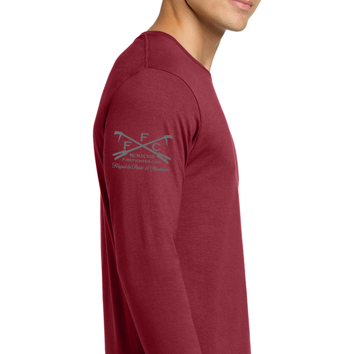 A man wearing a heathered burgundy long-sleeve t-shirt, shown from a side profile against a plain white background. The left chest features a gray printed graphic of crossed skis with the text 'ffc' #color_cardinal-red