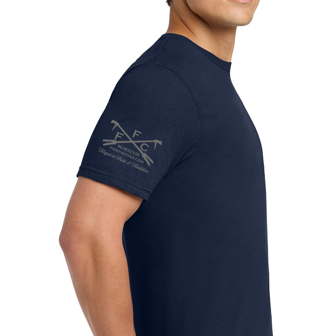 A man wearing a navy blue short-sleeve t-shirt, shown from a side/back angle against a plain white background. The left sleeve features a light gray printed logo for 'Ffc" #color_navy