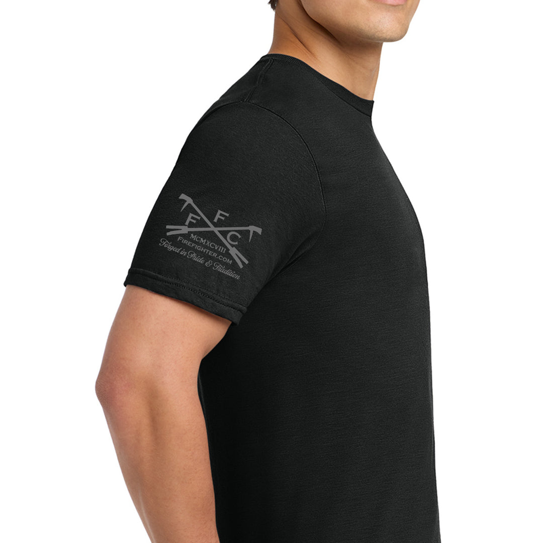 A man wearing a black short-sleeve t-shirt, shown from the side against a plain white background. The left sleeve features a gray printed graphic with the letters 'FFC' #color_black