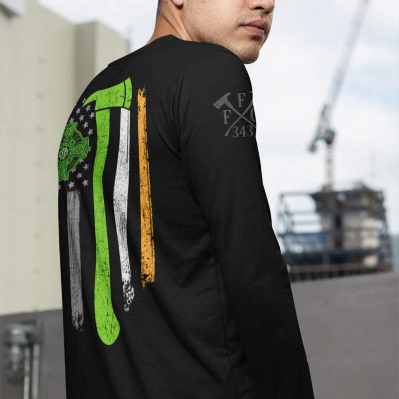 A man wearing a black firefighter long sleeve shirt with a full back design featuring a distressed USA flag accented by a green axe-perfect for fire department apparel