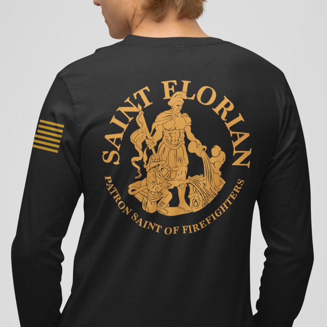 A man wearing a black firefighter long sleeve shirt with a full back design featuring the Saint Florian Patron Saint of Firefighters