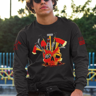 A man wearing a black firefighter long sleeve shirt showing the full-front design of a skull filled with firefighter tools