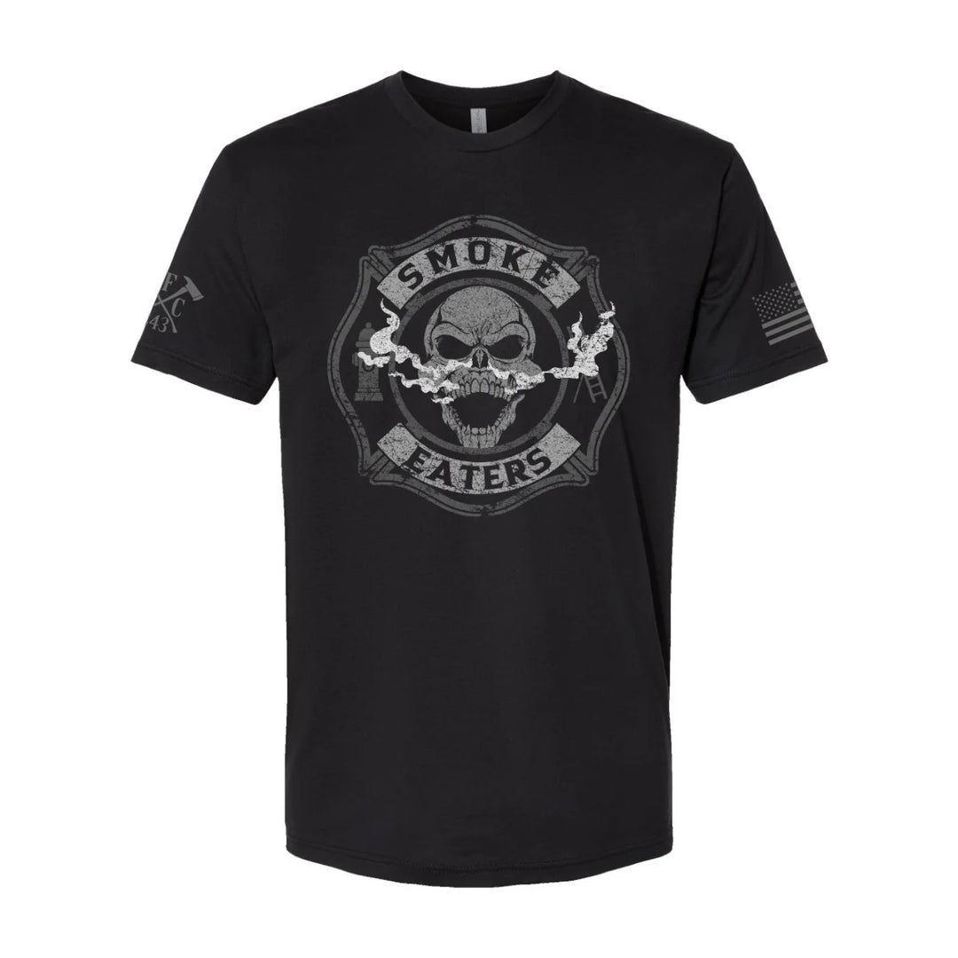 Front view of firefighter T-Shirt in black color featuring a full-front design print of a skull inhaling smoke, with a distressed grey and off-white look. 