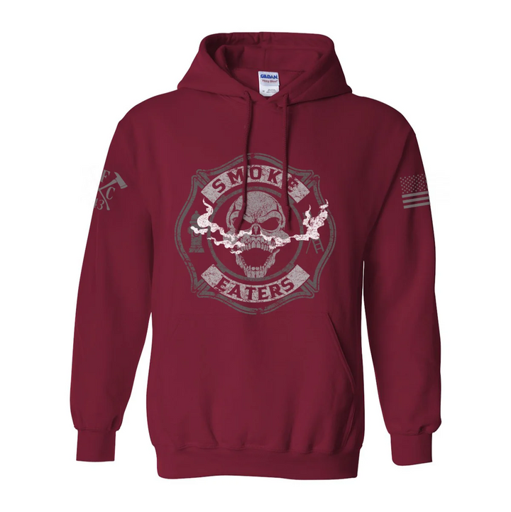 Front view of firefighter hoodies in red color featuring a full-front design print of a skull inhaling smoke, with a distressed grey and off-white look. 