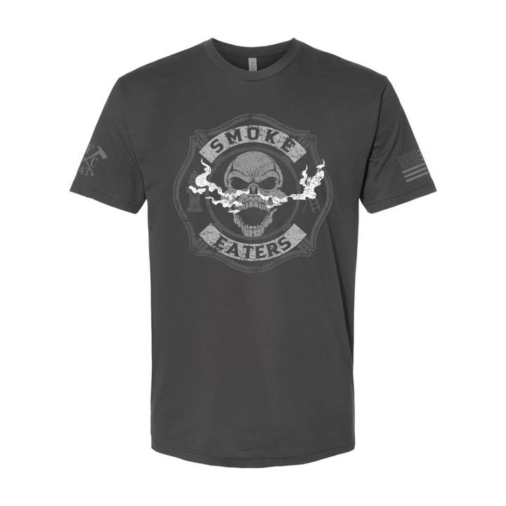 Front view of firefighter T-Shirt in heavy metal color featuring a full-front design print of a skull inhaling smoke, with a distressed grey and off-white look. 