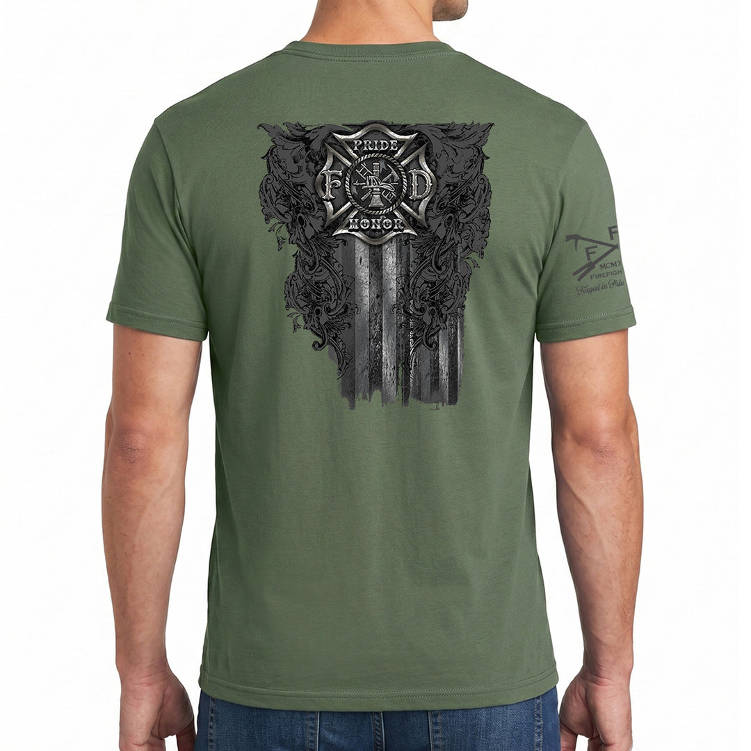 A man wearing an olive green t-shirt, viewed from the back. The shirt features a large distressed black graphic on the back with a firefighter's helmet, Maltese cross #color_military-green