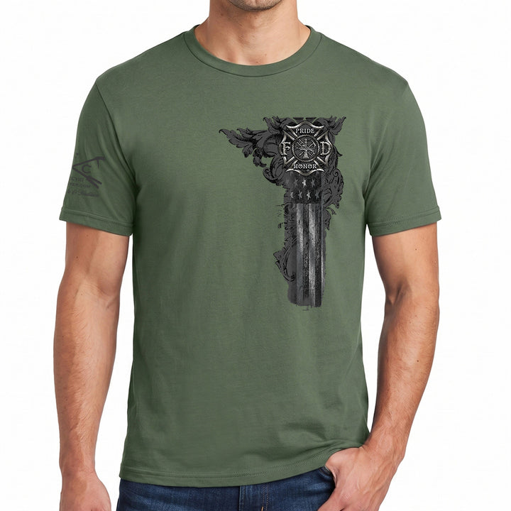 An olive green crewneck t-shirt with a detailed black and gray graphic of a firefighter maltese, worn by a model against a plain white background. #color_military-green