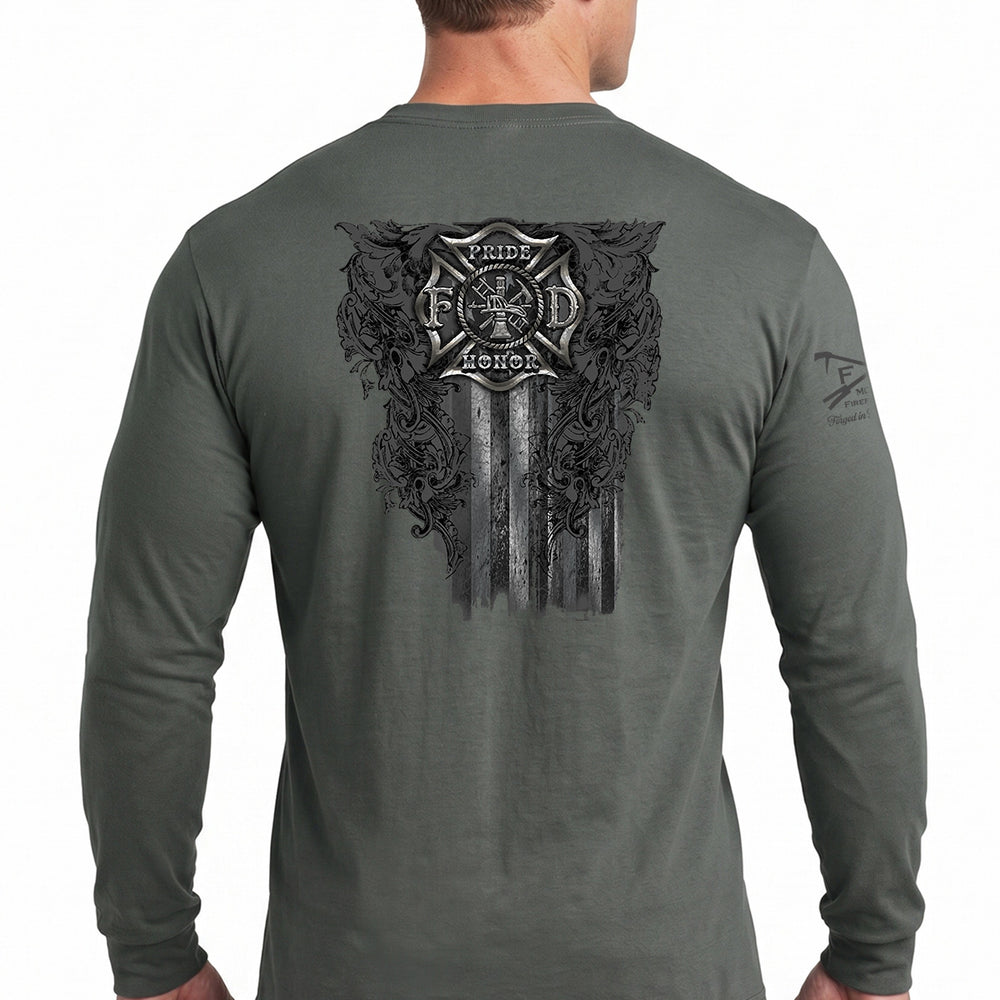 A man wearing a dark gray long-sleeve t-shirt, viewed from the back. The shirt features a large black graphic print on the back with a firefighter's Maltese cross, the words 'Pride & Honor', and a distressed American flag design. #color_charcoal