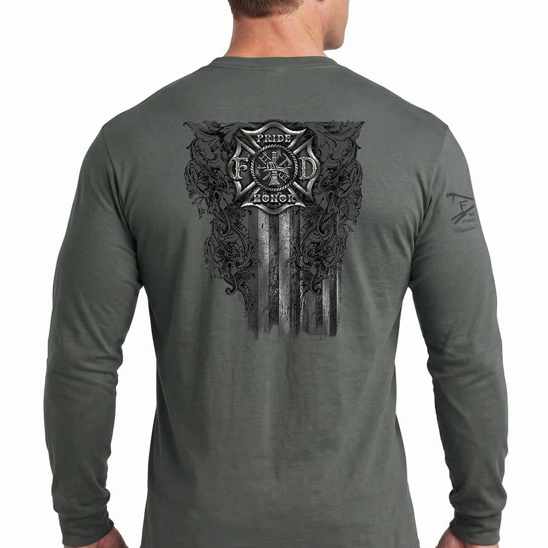 A man wearing a dark gray long-sleeve t-shirt, viewed from the back. The shirt features a large black graphic print on the back with a firefighter's Maltese cross, the words 'Pride & Honor', and a distressed American flag design. #color_charcoal