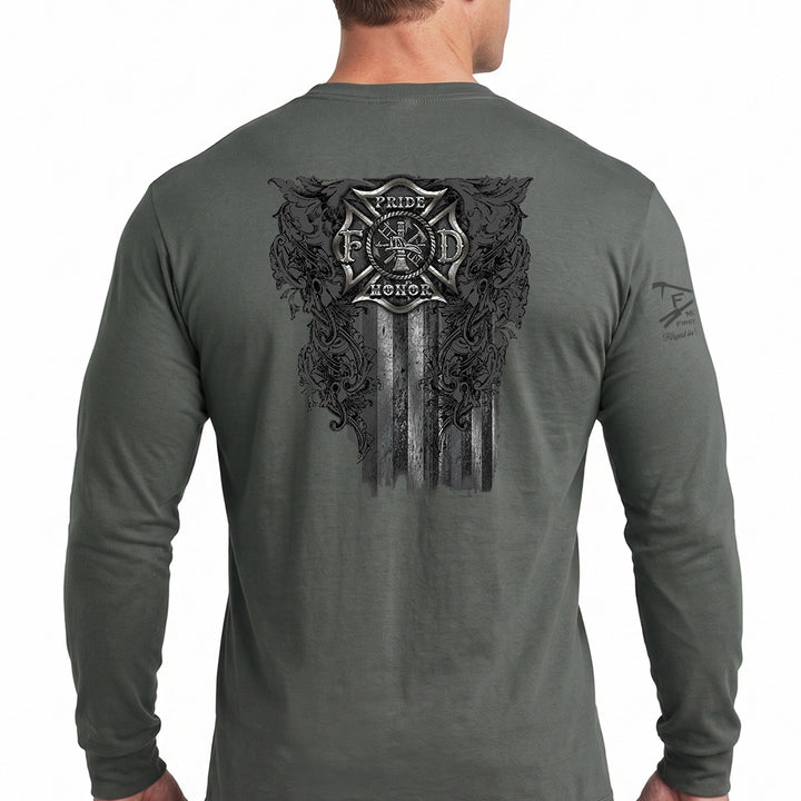 A man wearing a dark gray long-sleeve t-shirt, viewed from the back. The shirt features a large black graphic print on the back with a firefighter's Maltese cross, the words 'Pride & Honor', and a distressed American flag design. #color_charcoal