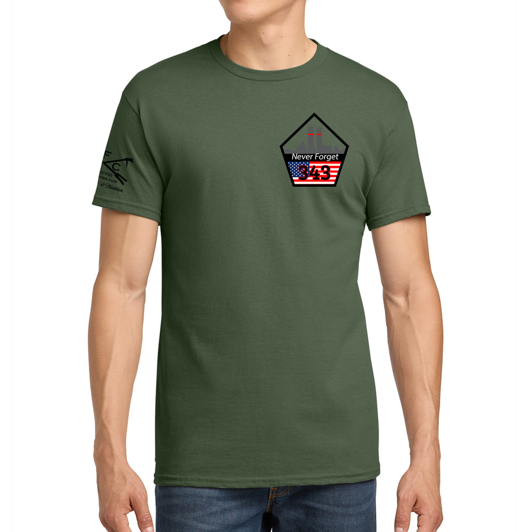 A man wearing an olive green crewneck t-shirt with a 'Never Forget' graphic on the left chest and a black graphic on the right sleeve, paired with blue jeans against a plain white background. #color_military-green