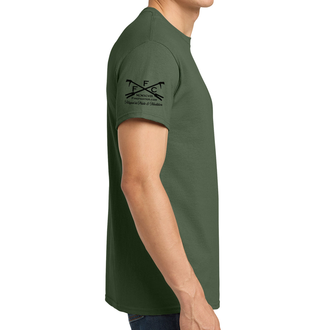 A man wearing a dark green short-sleeve t-shirt, shown from a side profile view against a plain white background. The left sleeve features a black printed graphic of crossed golf clubs with the letters 'FFC' #color_military-green