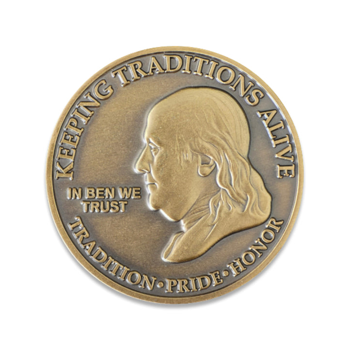 Firefighter.com exclusive 'In Ben We Trust' challenge coin featuring Benjamin Franklin and 'Keeping Tradition' motto. Antique bronze finish.