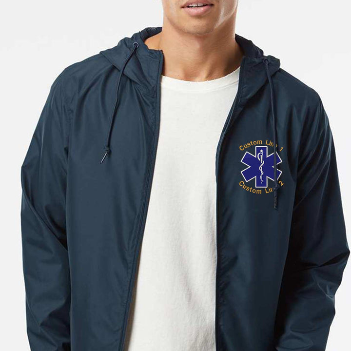 Breathable windbreaker for emergency medical personnel with Star of Life logo and customizable text lines for personalized wear.