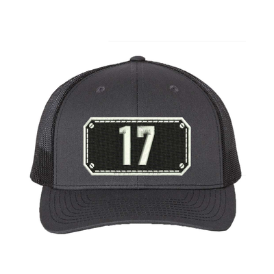 Richardson Trucker Hat.  Black Shield design with your fire station number embroidered in the shield.  Hat color charcoal/black.